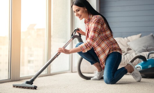 Lady vaccuming carpet | The Carpet Stop