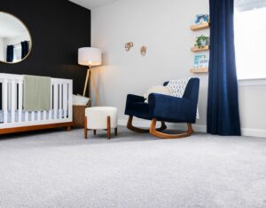 Carpet flooring with blue couch | The Carpet Stop