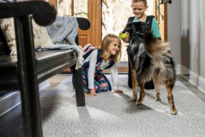 Kids playing with dog on carpet floor | The Carpet Stop